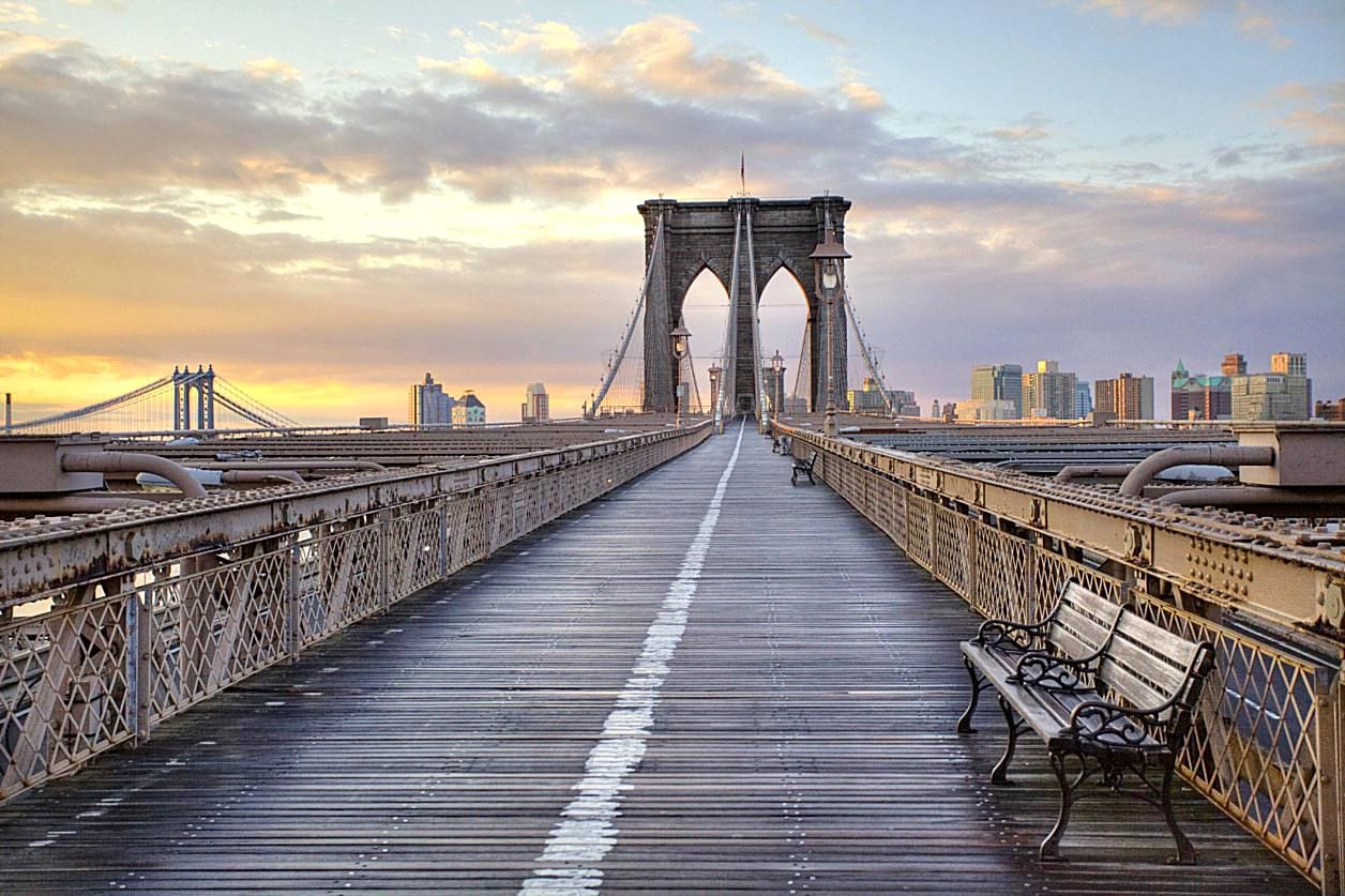 A bench on the side of a bridge.