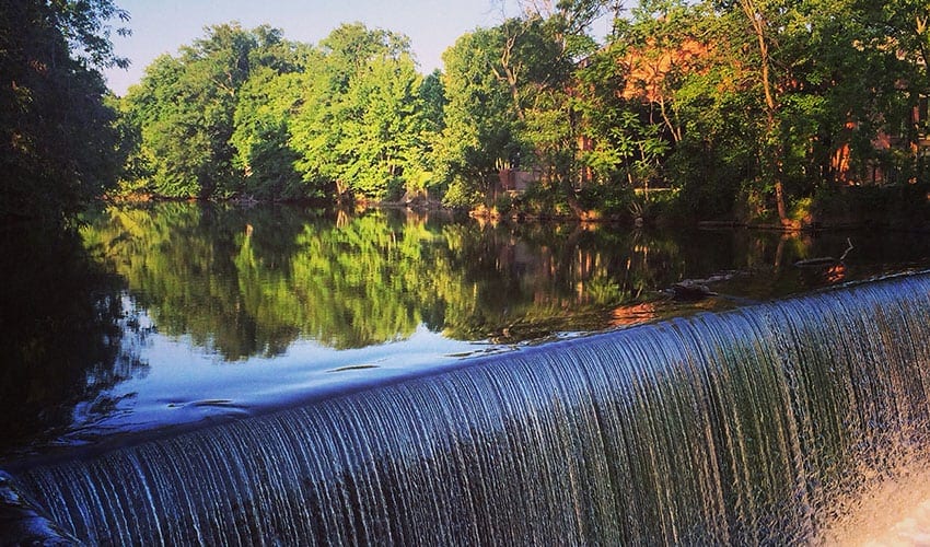 A waterfall in the middle of a lake.