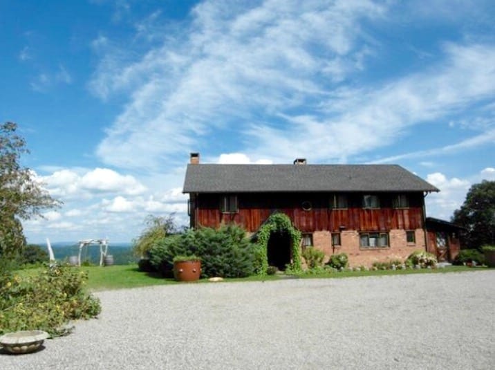 A house with a sky background and some bushes