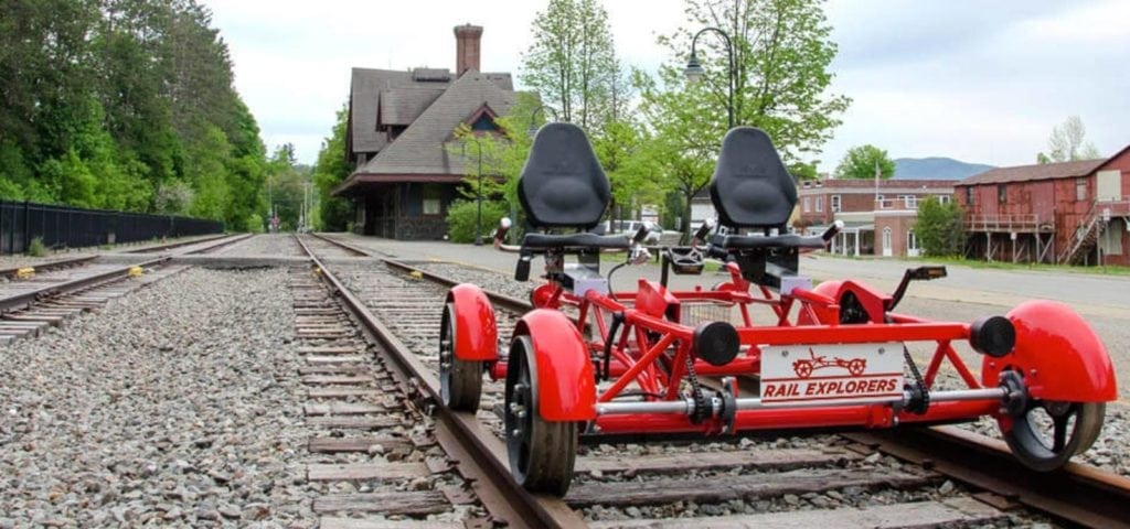 A red bike with two seats on the side of it.