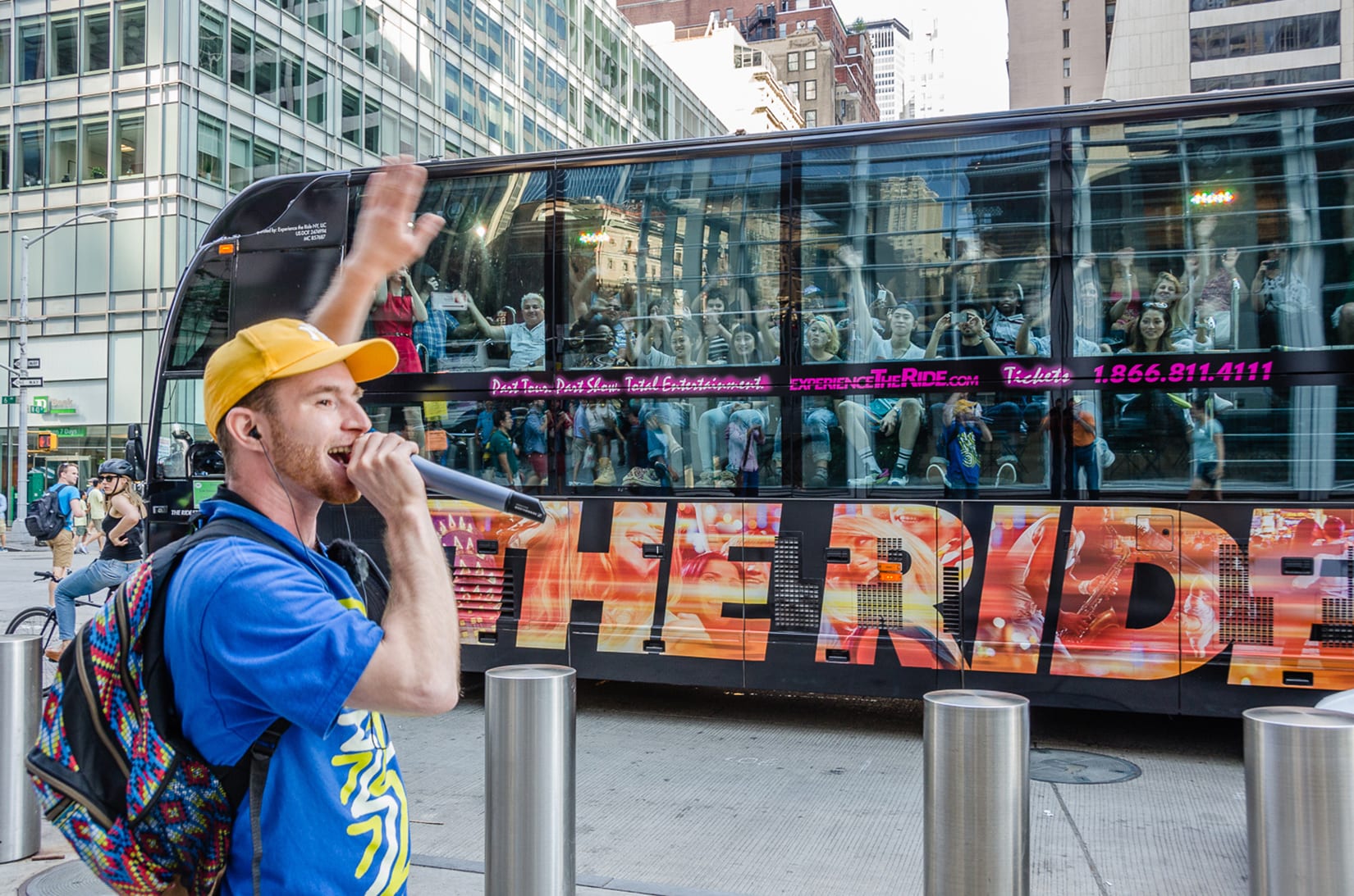 A man standing next to a bus on the street.