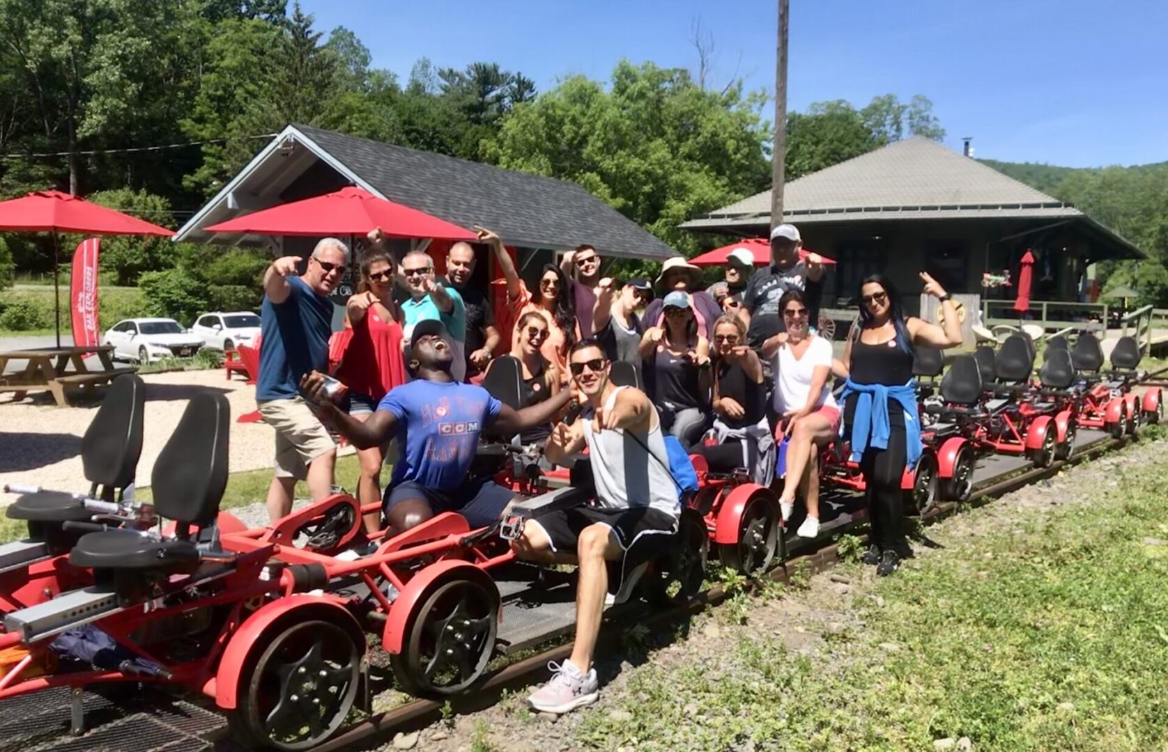 A group of people sitting on red bikes.