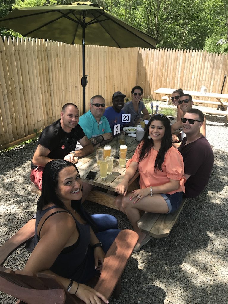 A group of people sitting around a picnic table.