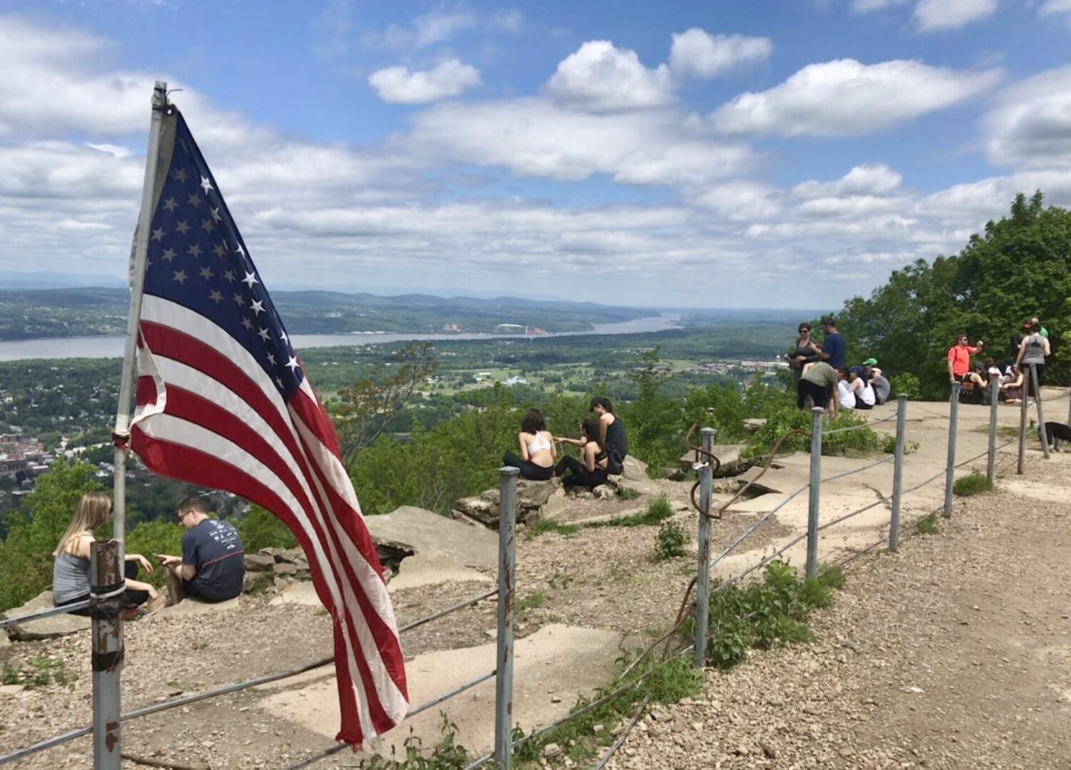 A flag is hanging on the side of a fence.