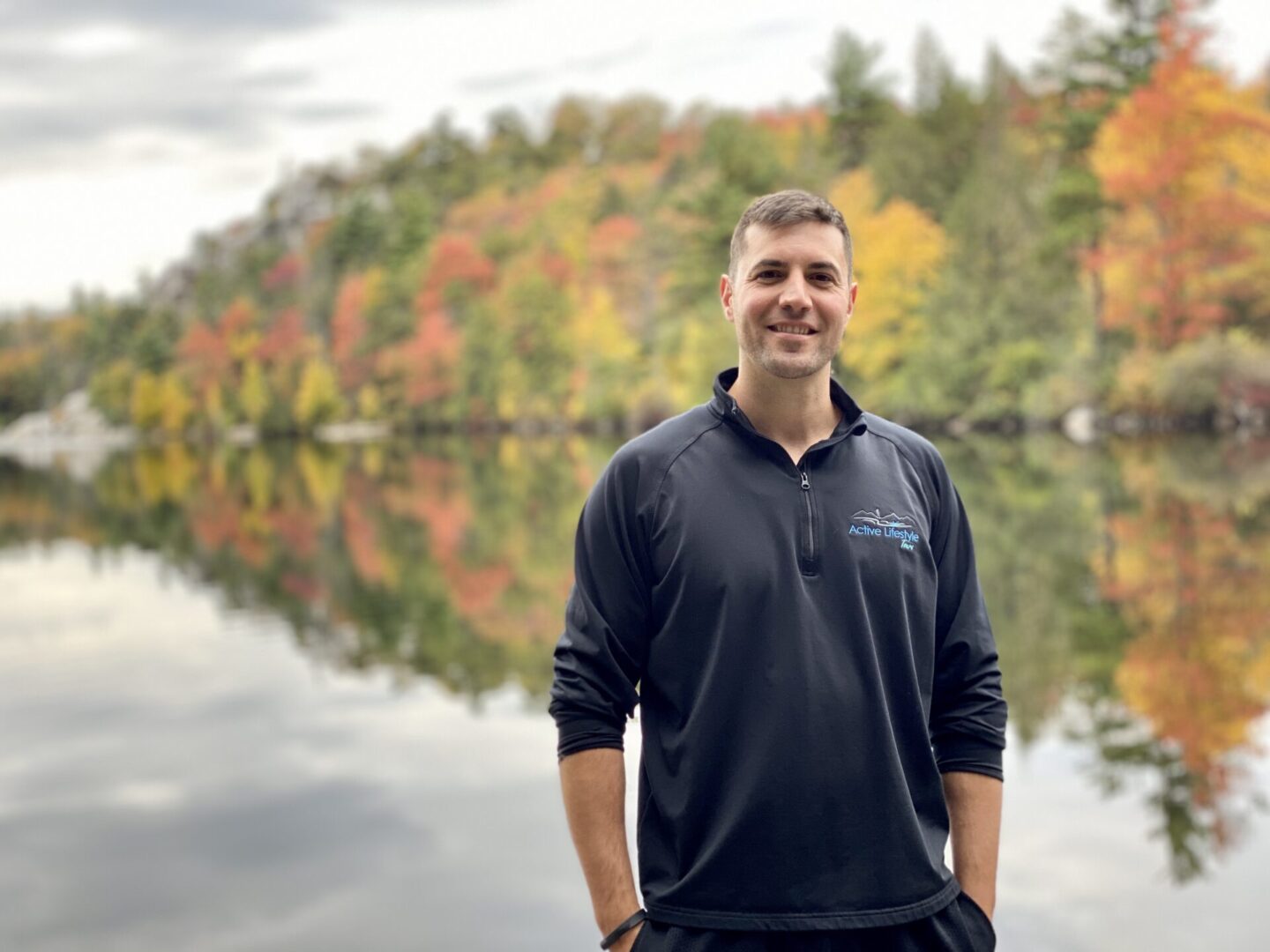 A man standing in front of the water.