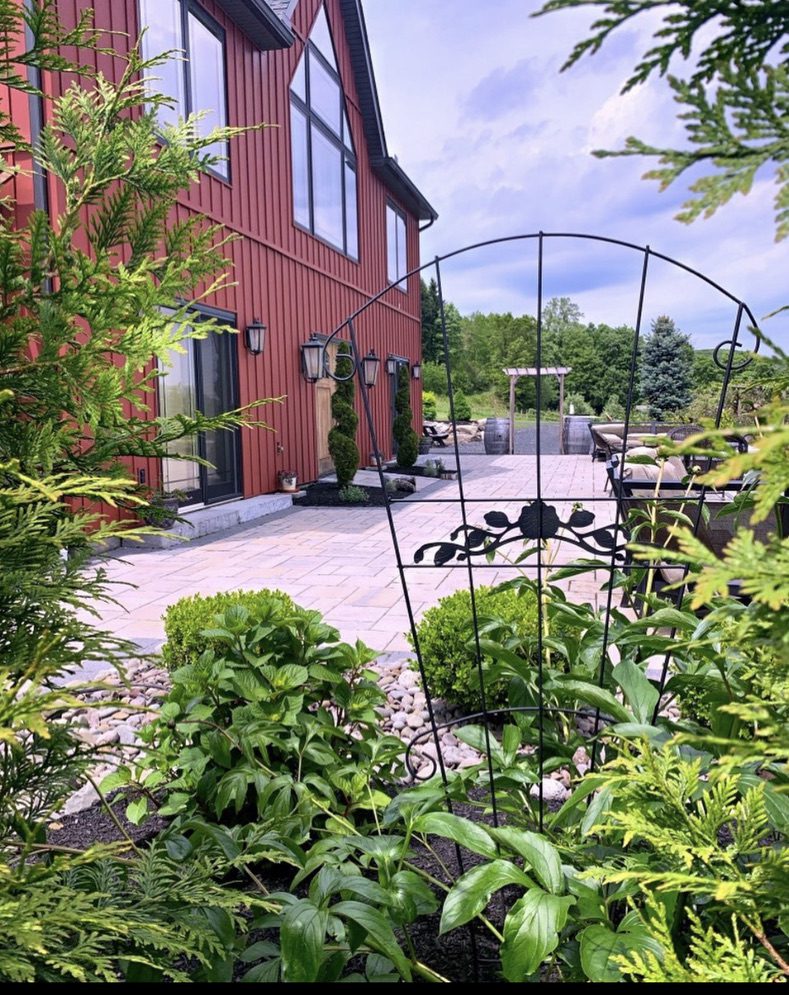 A red barn with a garden in the foreground