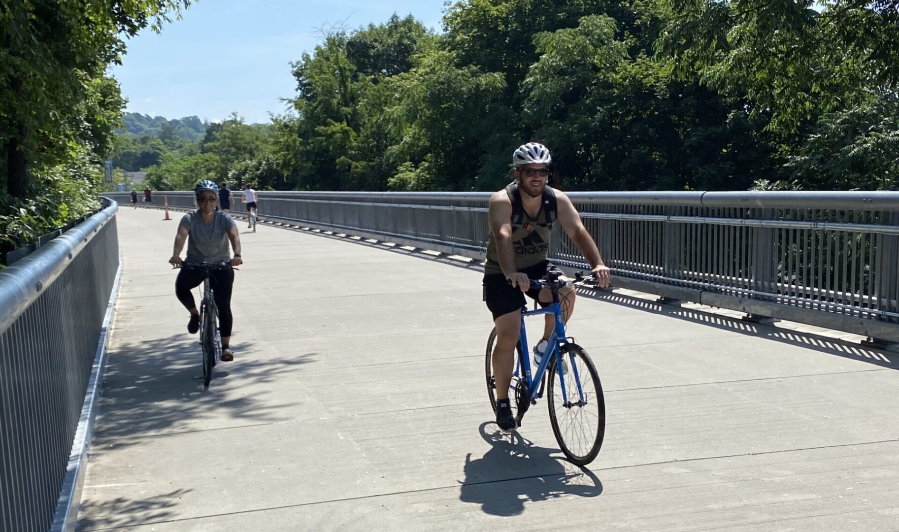 A man riding his bike on the side of a road.