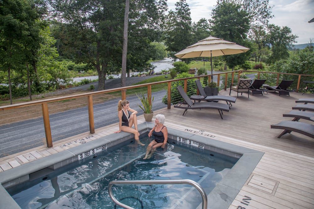 Two people sitting in a pool of water