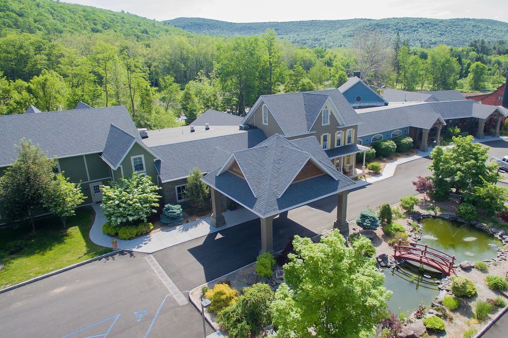 A large house with many trees and bushes