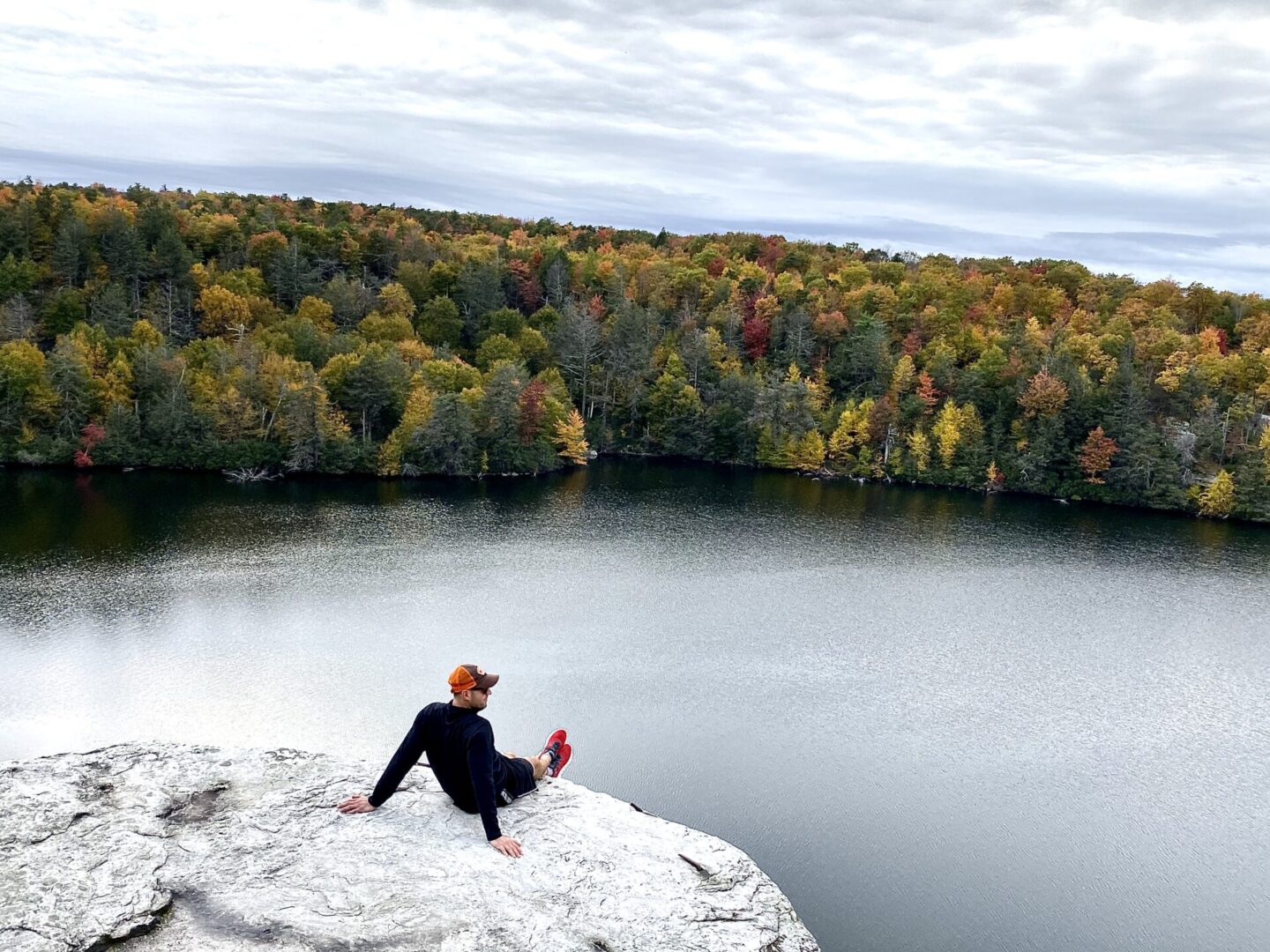 A person sitting on the edge of a cliff