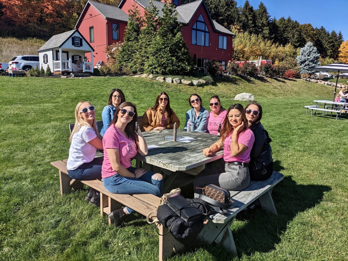 A group of people sitting at a picnic table.