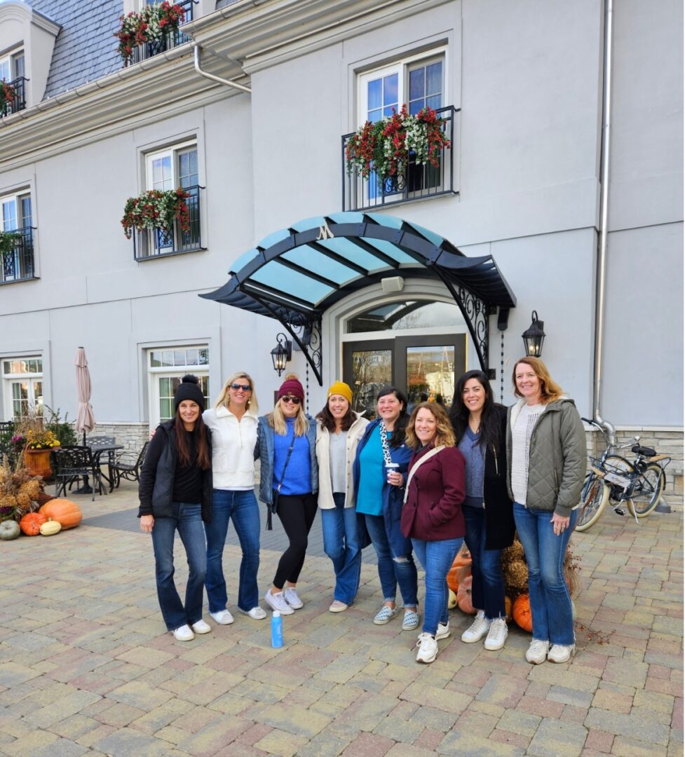 A group of people standing in front of a building.