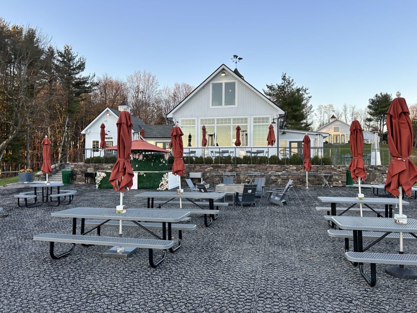 A group of picnic tables with umbrellas in the background.