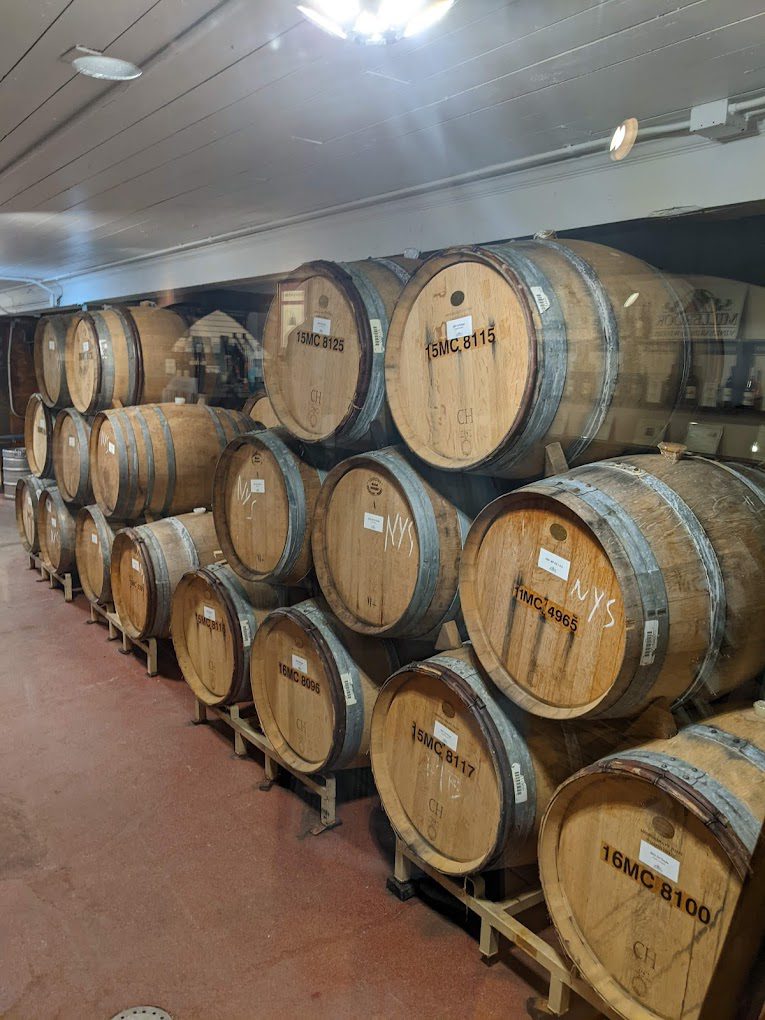 A bunch of barrels are stacked up in the room