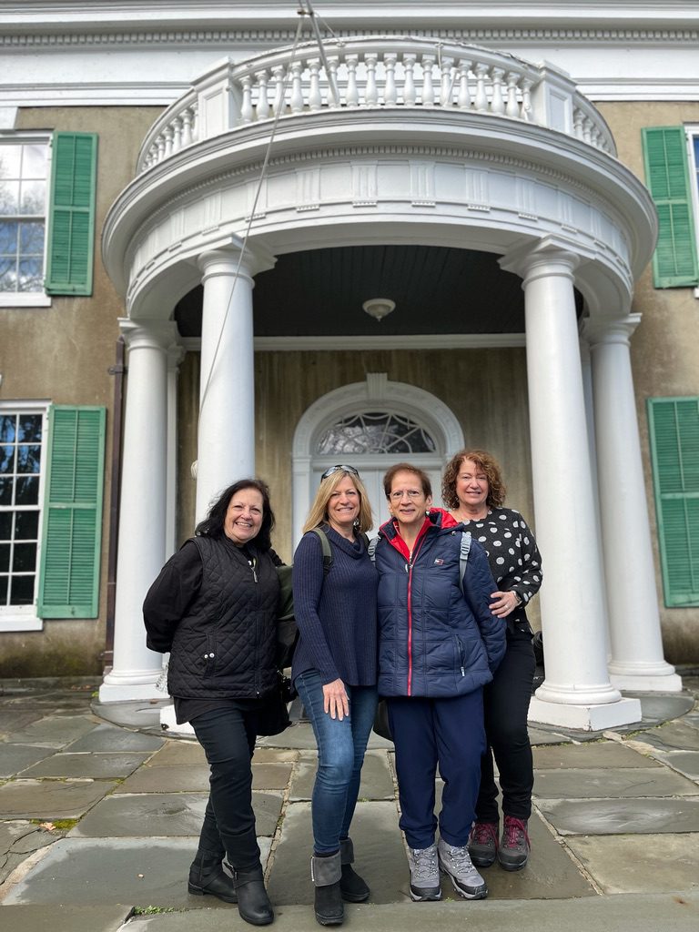 A group of women standing in front of a building.