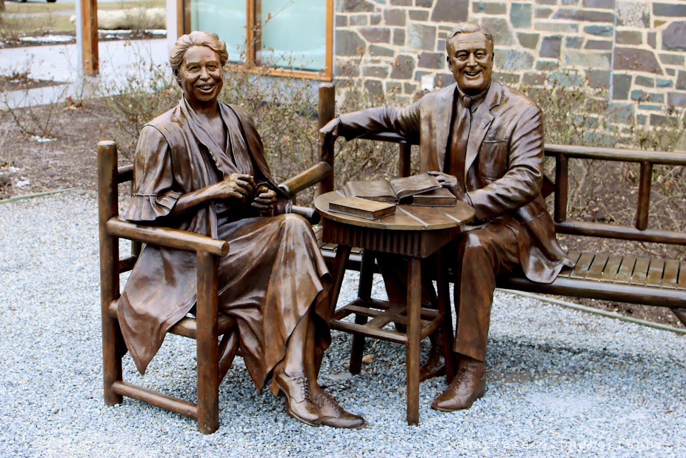 A statue of two people sitting at a table.