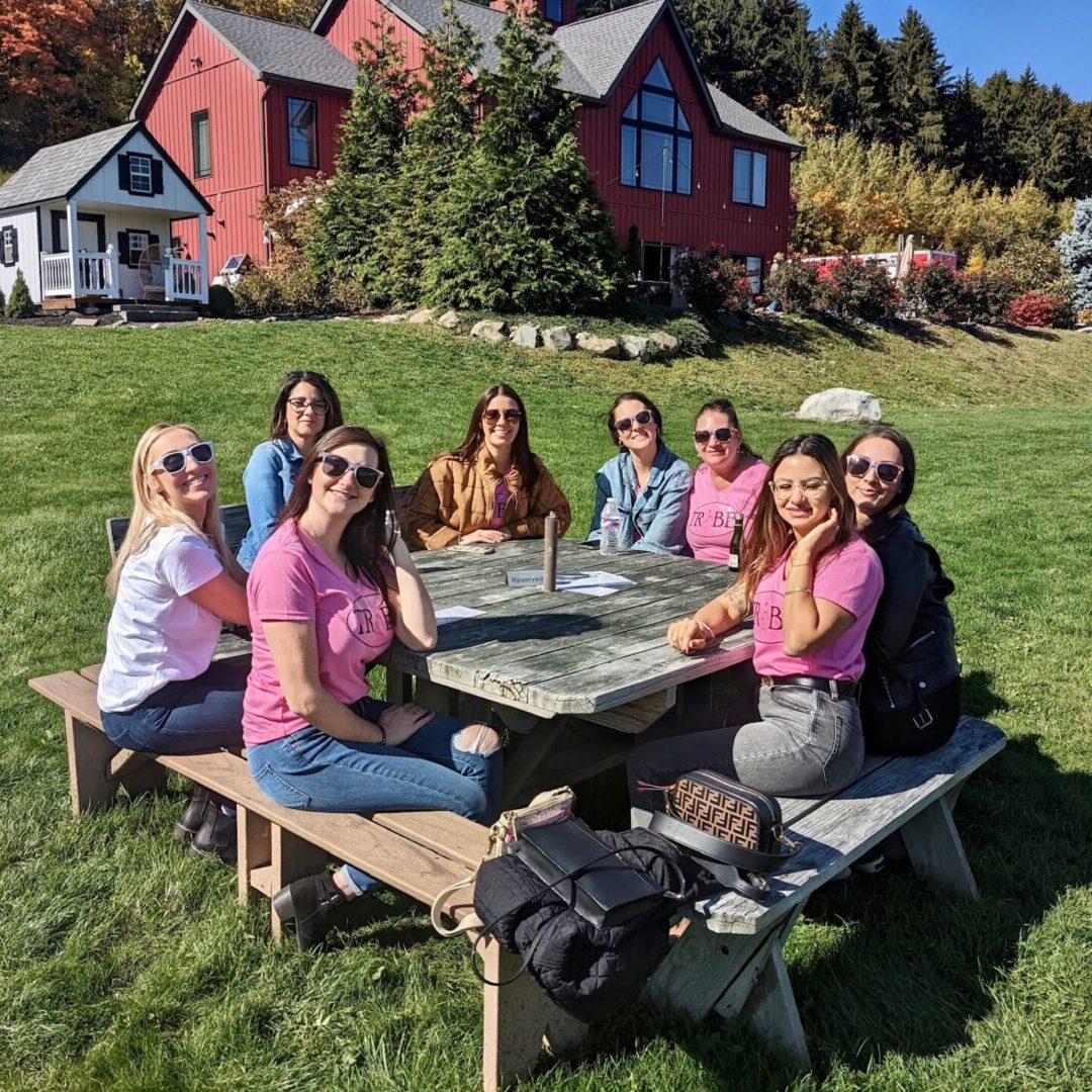 A group of people sitting at a picnic table.