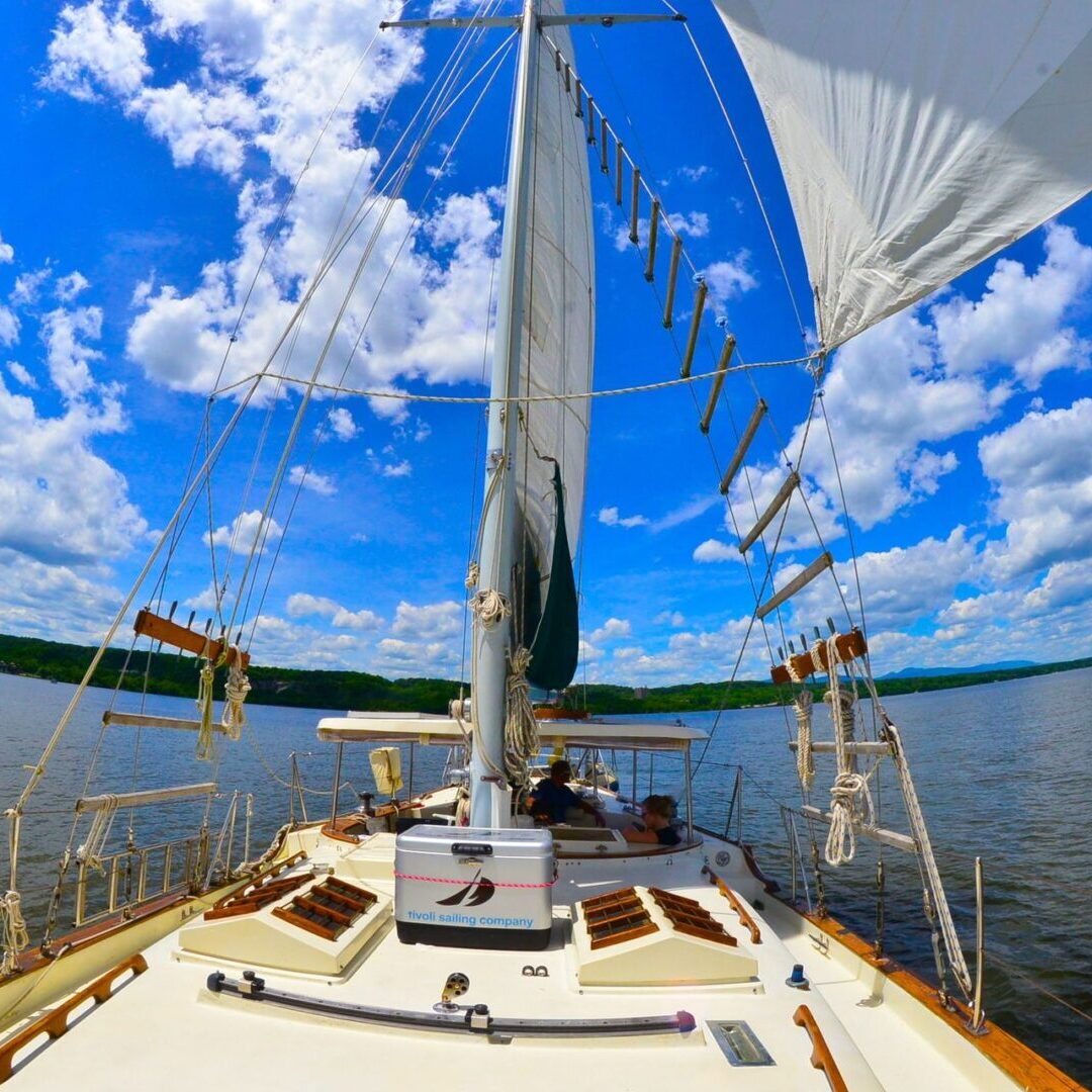 A boat is sailing on the water under a blue sky.