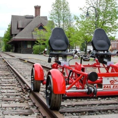 A red bike with two seats on the side of it.